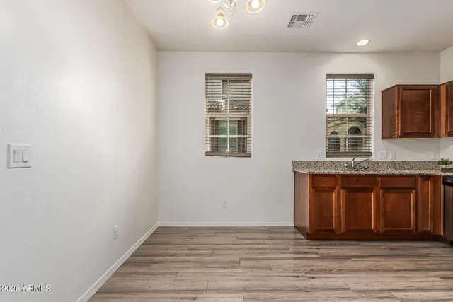 a bathroom with a granite countertop sink and mirror