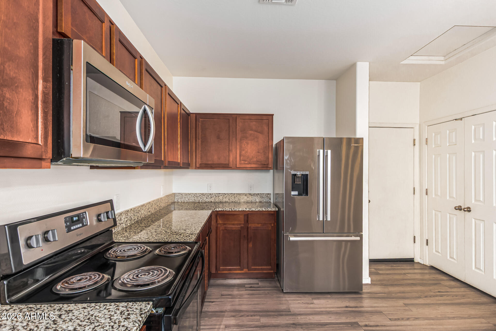 5446 Fulton Street Phoenix, AZ 85043 - Photo 13 of 42 a kitchen with a stove a refrigerator and a microwave