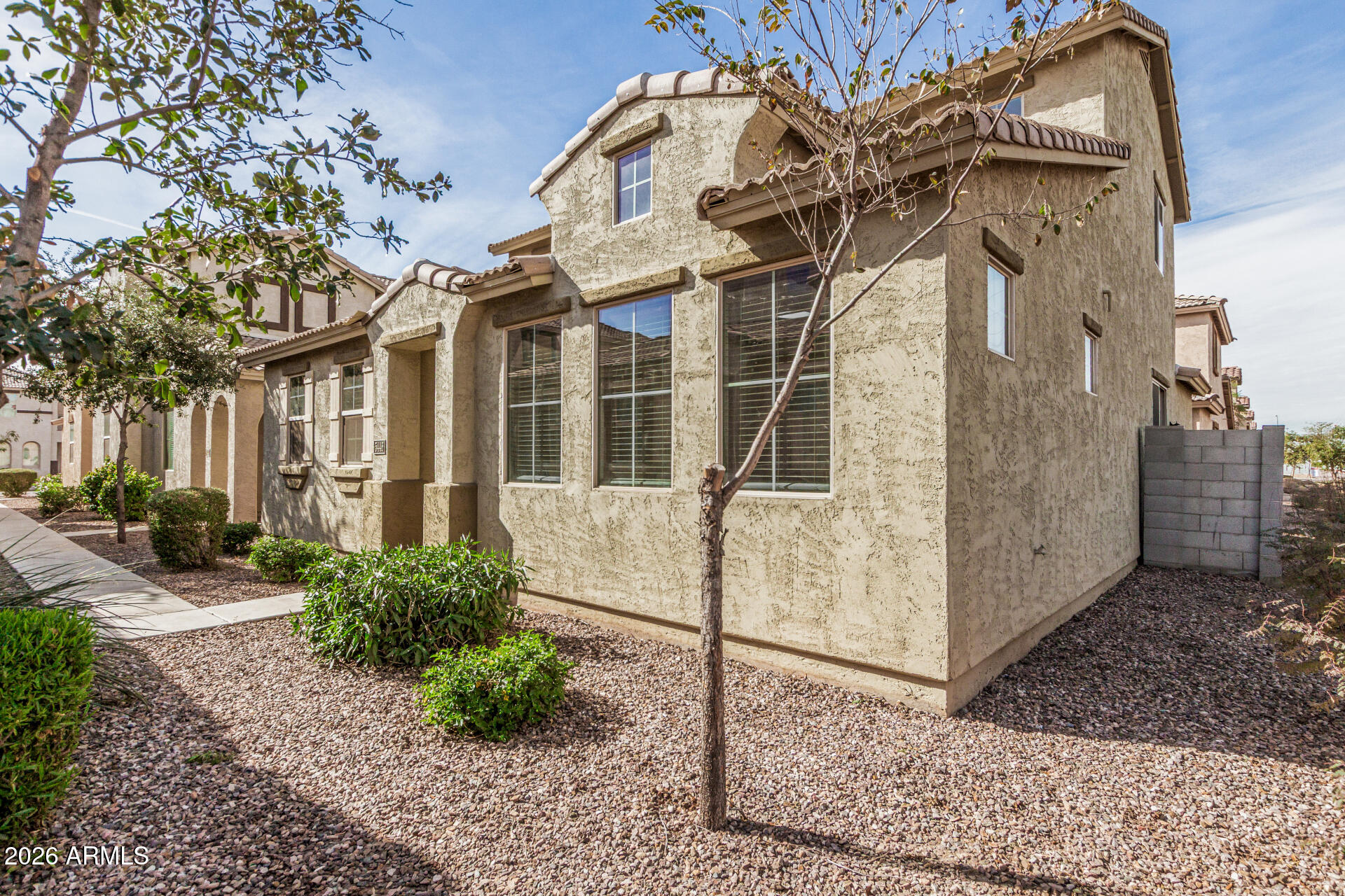 5446 Fulton Street Phoenix, AZ 85043 - Photo 3 of 42 a view of a white house with a large windows and flower plants