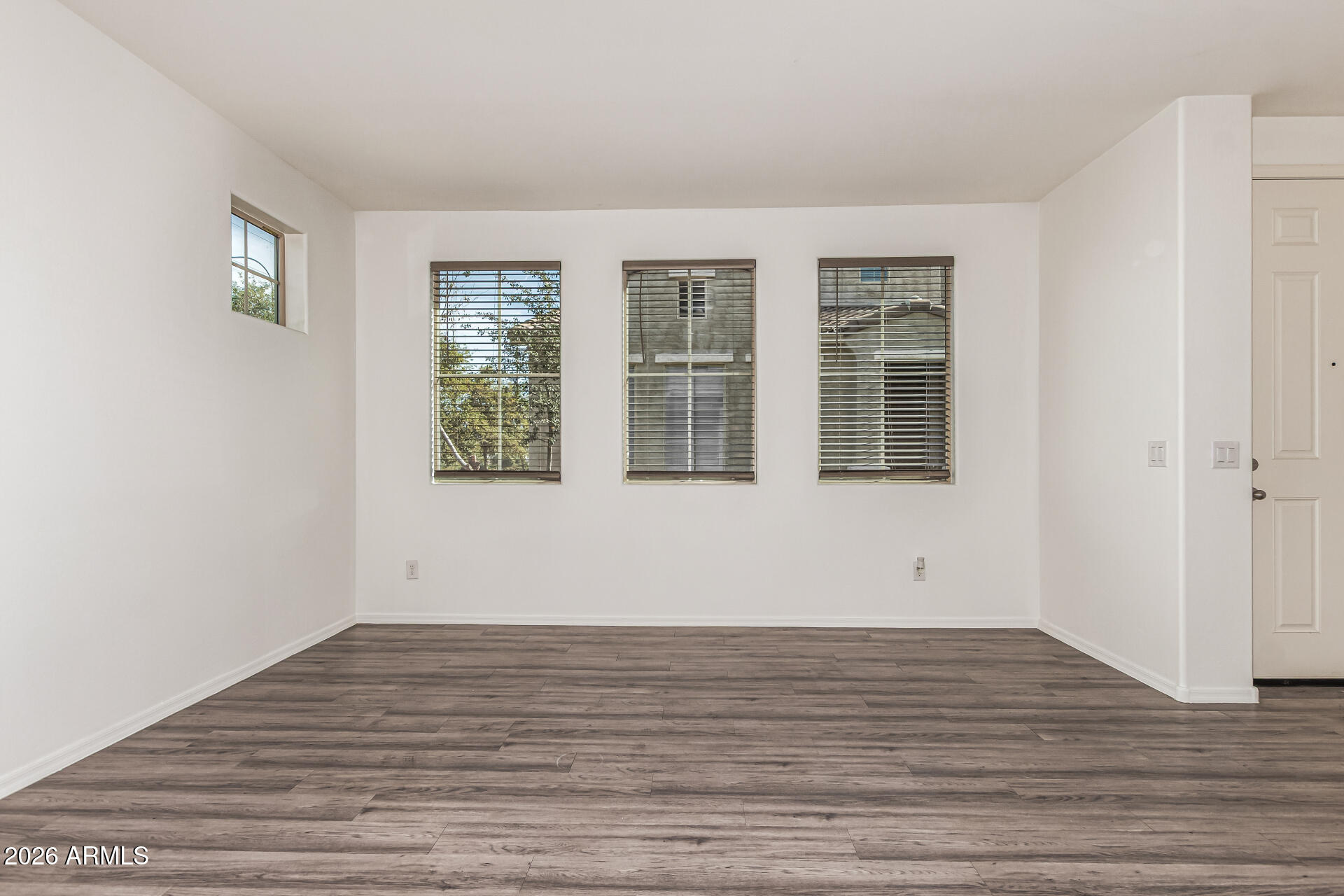 5446 Fulton Street Phoenix, AZ 85043 - Photo 8 of 42 a view of empty room with wooden floor and fan