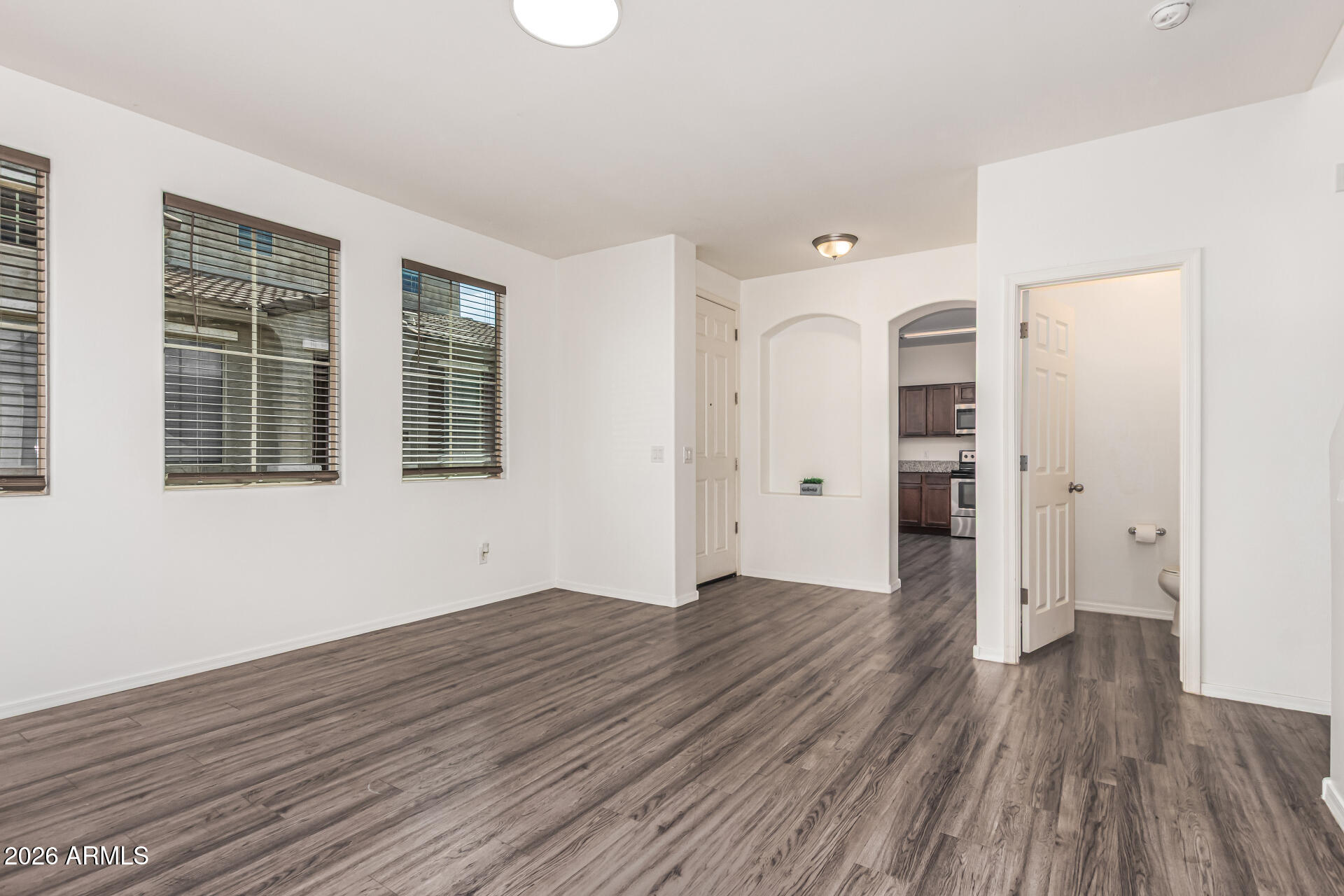 5446 Fulton Street Phoenix, AZ 85043 - Photo 9 of 42 wooden floor in an empty room with a window