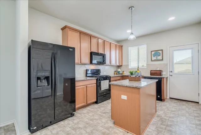 a kitchen with cabinets and stainless steel appliances