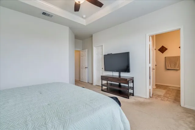 a spacious bedroom with a bed and window