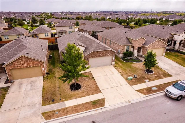 an aerial view of residential houses with outdoor space