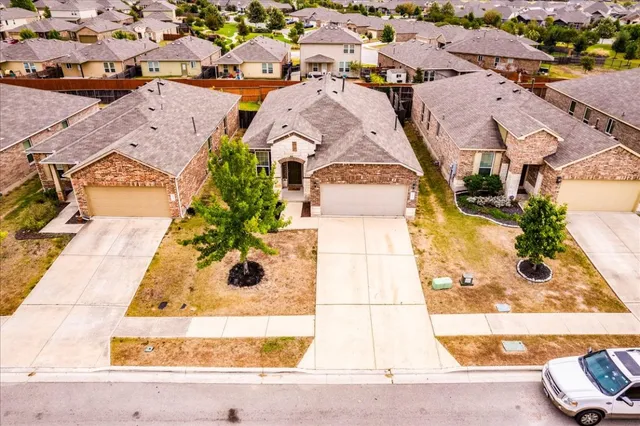 an aerial view of residential houses with outdoor space