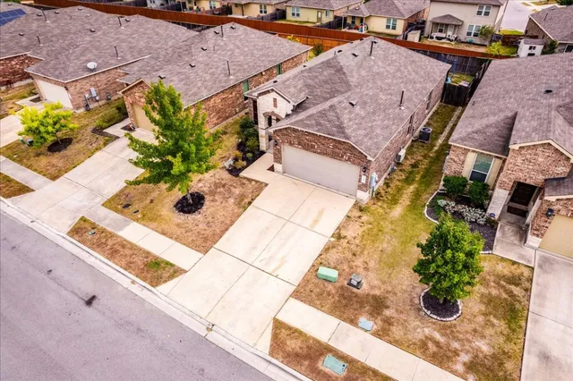 an aerial view of a house with a yard
