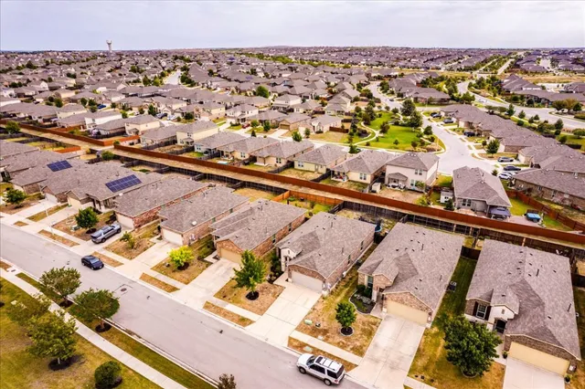 an aerial view of residential houses with outdoor space