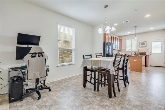 a view of a dining room with furniture and a chandelier