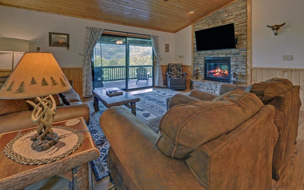 445 Tranquil Cove Road Murphy, NC 28906 - Photo 12 of 77 a living room with furniture a flat screen tv and a fireplace
