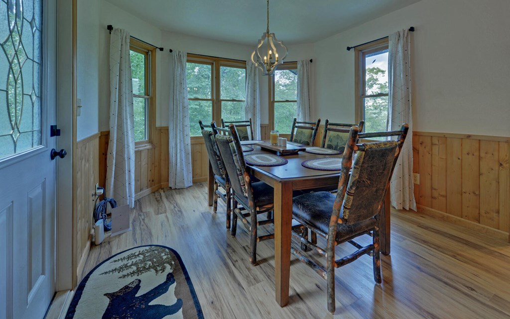 445 Tranquil Cove Road Murphy, NC 28906 - Photo 16 of 77 a view of a dining room with furniture window and wooden floor