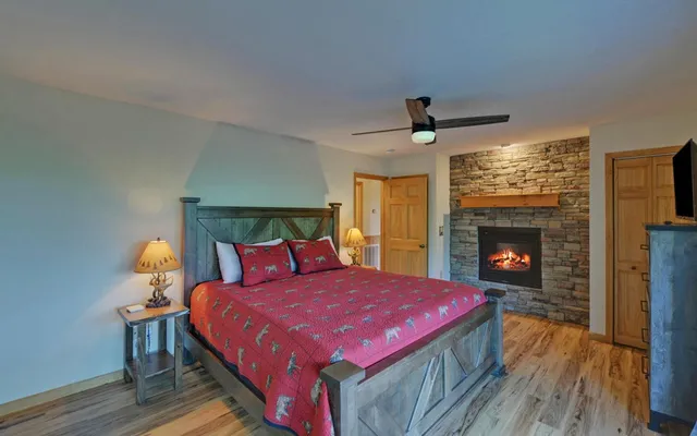 a bedroom with a bed and a flat screen tv