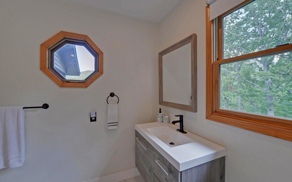 445 Tranquil Cove Road Murphy, NC 28906 - Photo 22 of 77 a bathroom with a sink and a mirror