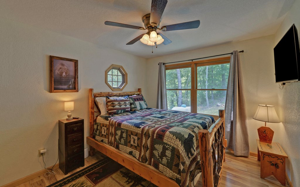 445 Tranquil Cove Road Murphy, NC 28906 - Photo 25 of 77 a bed sitting in a bedroom next to a window