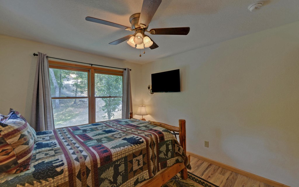 445 Tranquil Cove Road Murphy, NC 28906 - Photo 26 of 77 a bedroom with a bed and a flat screen tv
