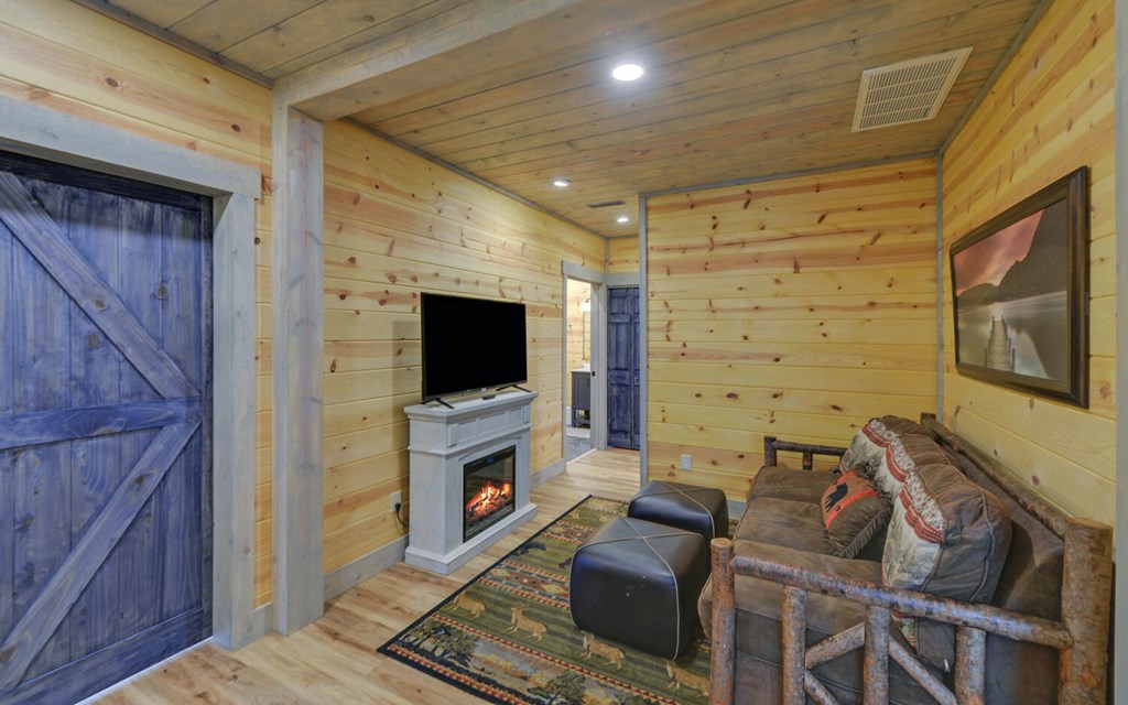 445 Tranquil Cove Road Murphy, NC 28906 - Photo 39 of 77 a living room with furniture a flat screen tv and a fireplace