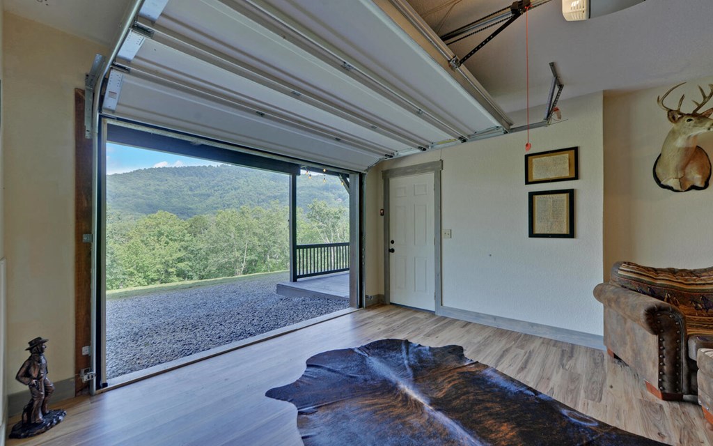 445 Tranquil Cove Road Murphy, NC 28906 - Photo 47 of 77 a living room with a bed and a large window with wooden floor