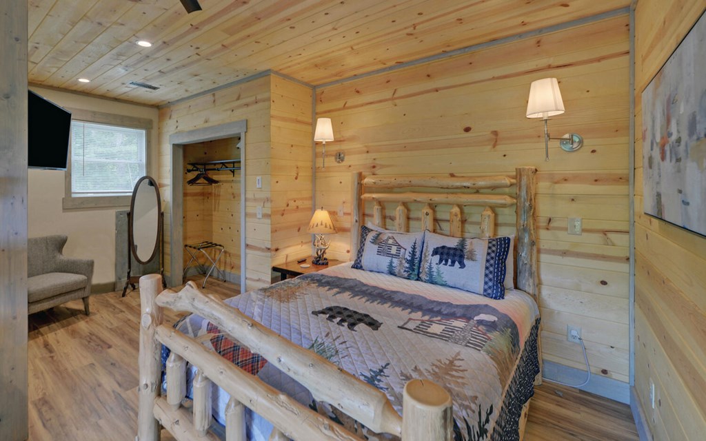 445 Tranquil Cove Road Murphy, NC 28906 - Photo 49 of 77 a bedroom with a bed a mirror and desk