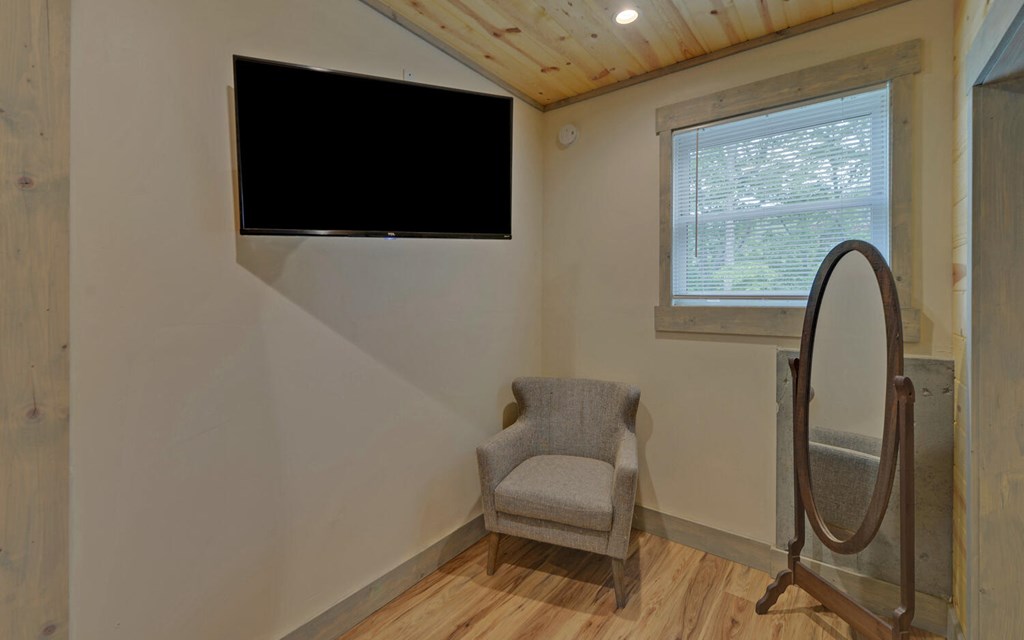 445 Tranquil Cove Road Murphy, NC 28906 - Photo 50 of 77 a living room with a flat screen tv and a window