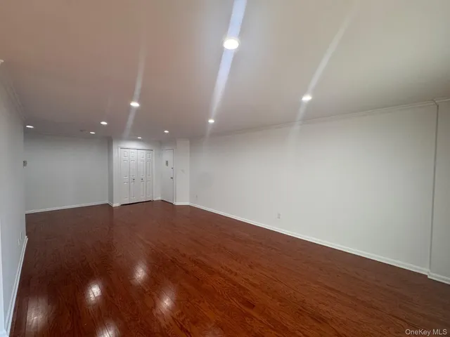 an empty room with wooden floor