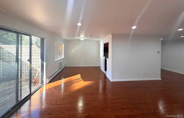 a view of a room with wooden floor