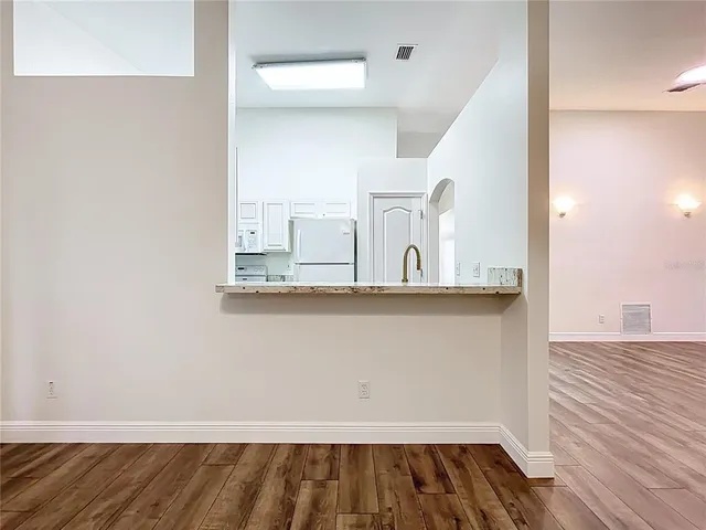 a view of an empty room and wooden floor