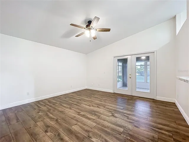 a view of an empty room and wooden floor