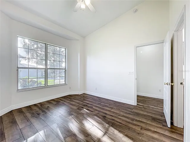 a view of empty room with wooden floor