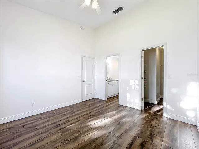 a view of an empty room with wooden floor