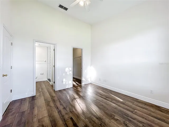 a bathroom with a granite countertop toilet a sink and a mirror