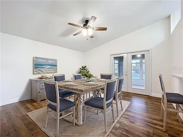 a view of a backyard with table and chairs and potted plants