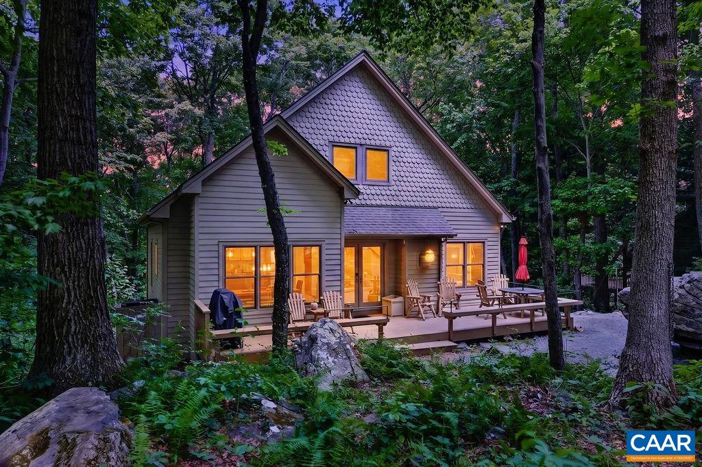 Charming Craftsman-style mountain home tucked away on a peaceful, private wooded lot, surrounded by nature and enhanced by stunning rock formations that add to the property's majestic setting.