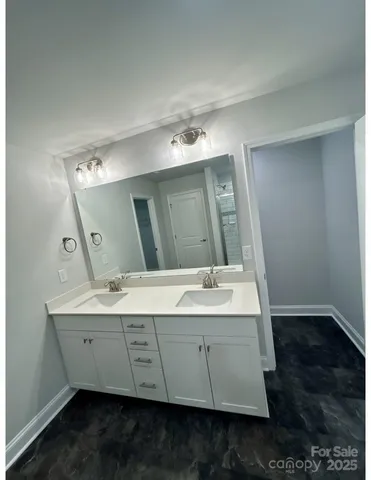 a bathroom with a double vanity sink and mirror