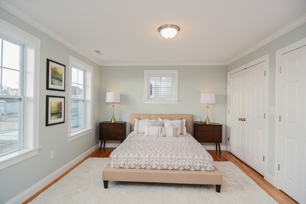 1400 Gorham Street, Unit 40 Lowell, MA 01852 - Photo 13 of 19 a bedroom with a bed and wooden floor