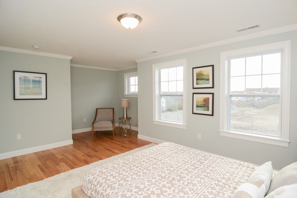1400 Gorham Street, Unit 40 Lowell, MA 01852 - Photo 14 of 19 a bedroom with a bed a table and a window