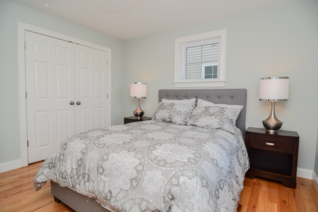 1400 Gorham Street, Unit 40 Lowell, MA 01852 - Photo 15 of 19 a bedroom with a bed and a night stand
