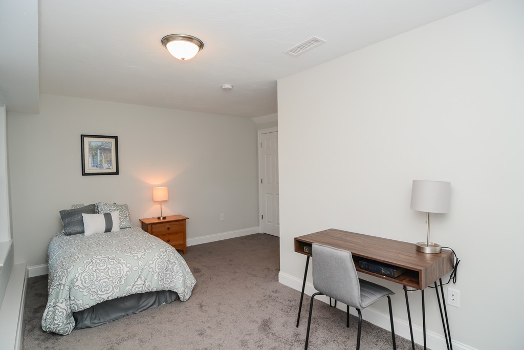1400 Gorham Street, Unit 40 Lowell, MA 01852 - Photo 16 of 19 a bedroom with a bed and a table