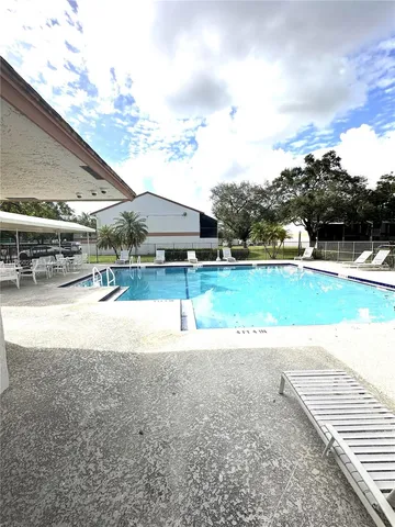 a view of a swimming pool with an outdoor space and seating area
