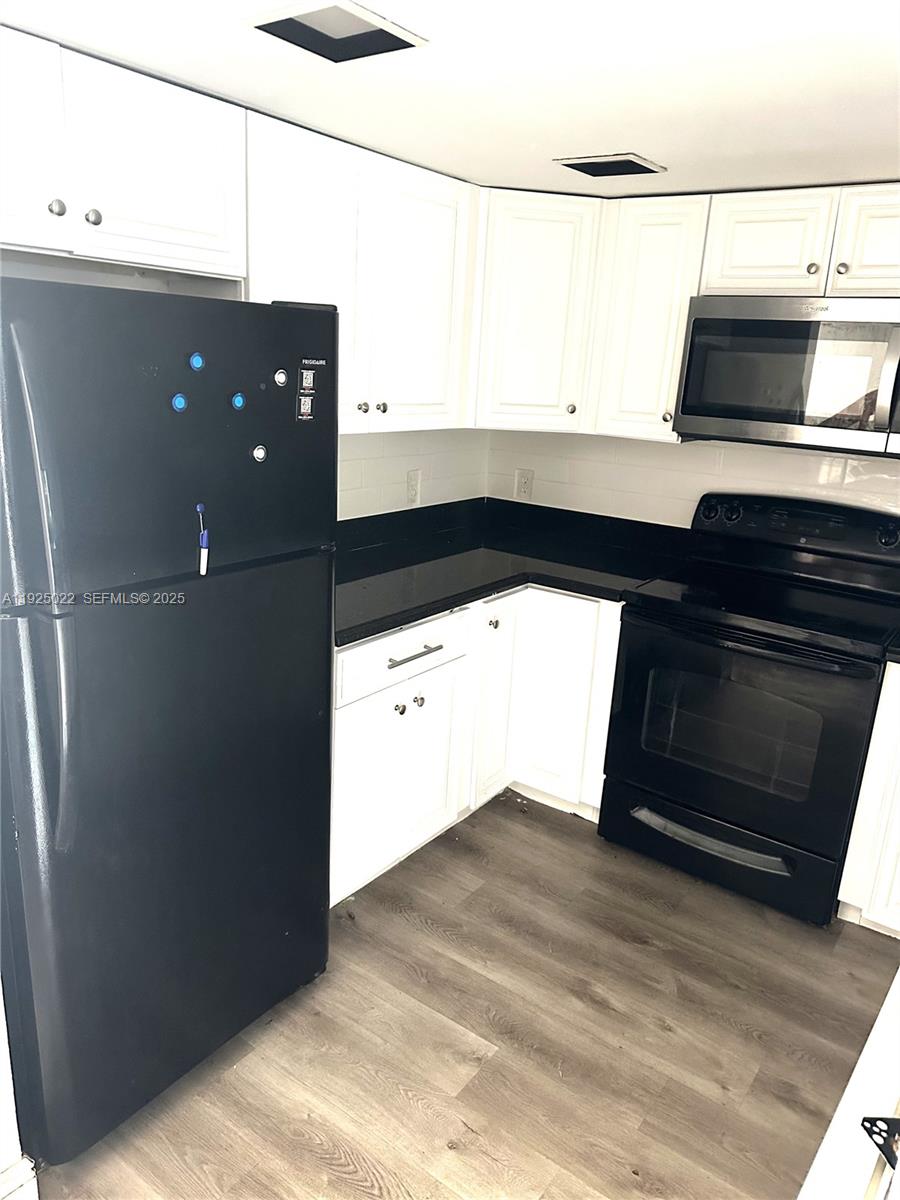 4220 Southwest 71st Terrace Davie, FL 33314 - Photo 12 of 16 a kitchen with a sink and a microwave