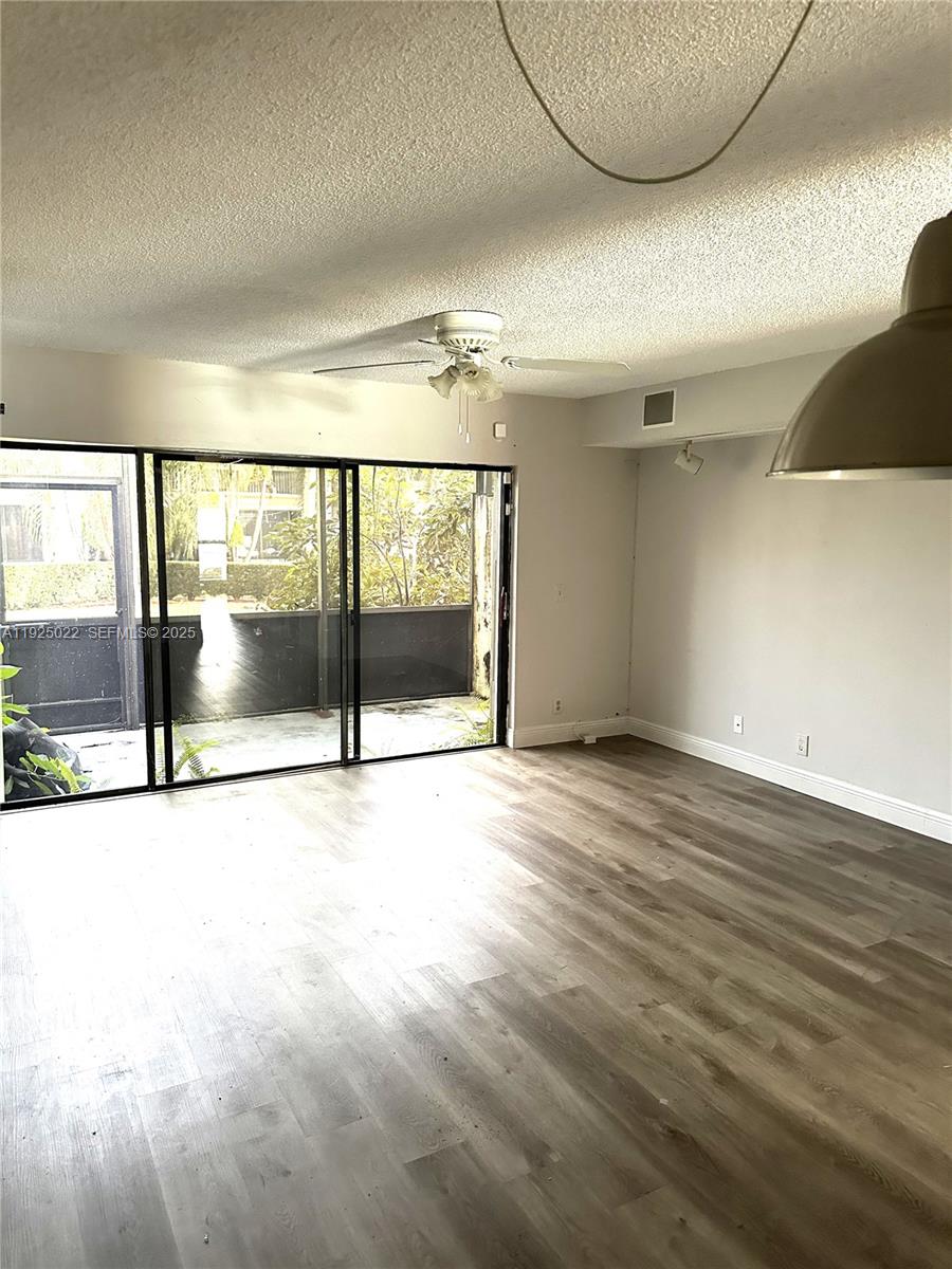 4220 Southwest 71st Terrace Davie, FL 33314 - Photo 13 of 16 an empty room with wooden floor and windows