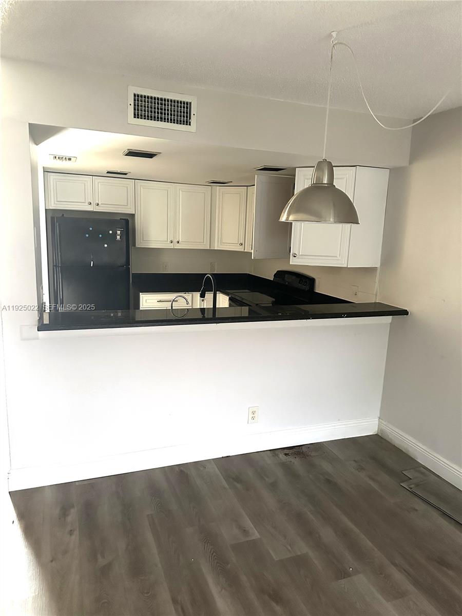 4220 Southwest 71st Terrace Davie, FL 33314 - Photo 14 of 16 a kitchen with a stove and a refrigerator