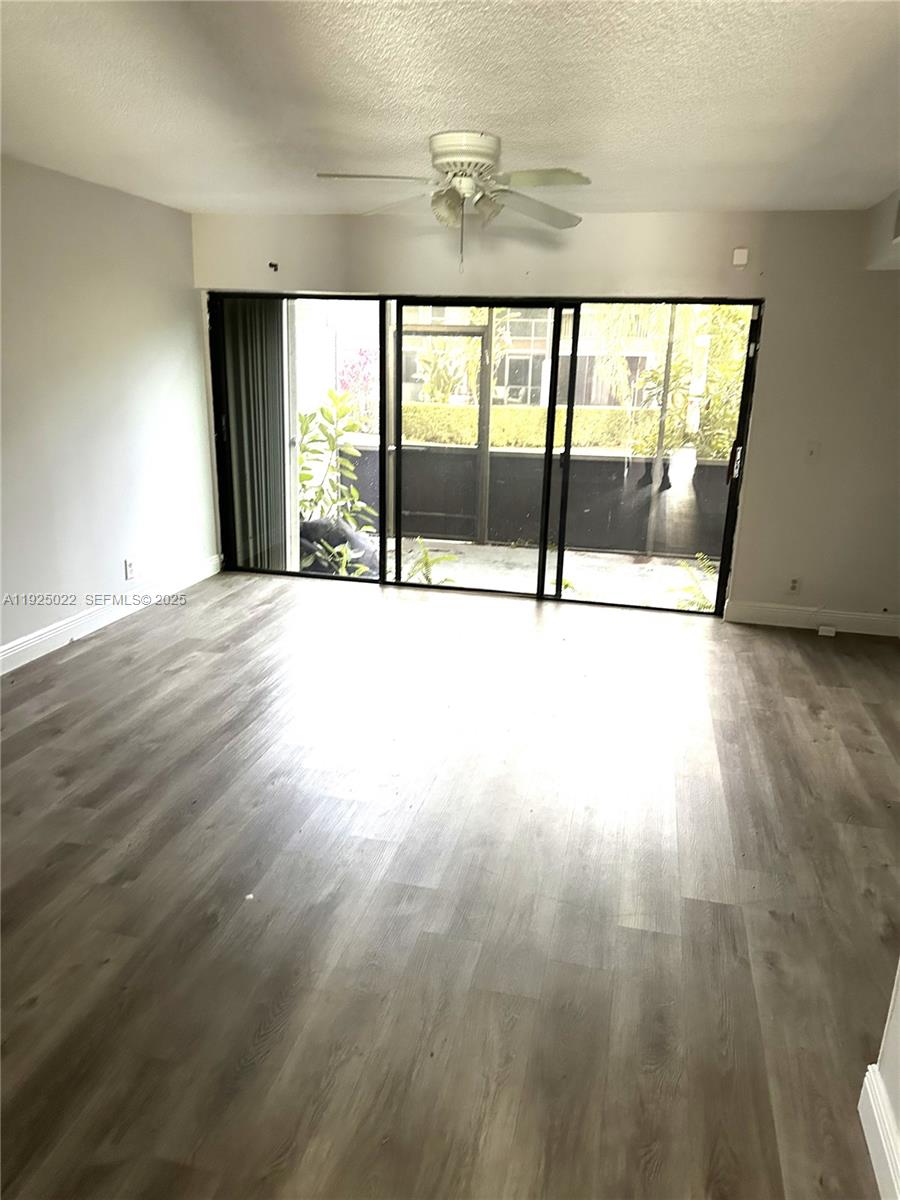 4220 Southwest 71st Terrace Davie, FL 33314 - Photo 15 of 16 a view of an empty room with wooden floor and a window