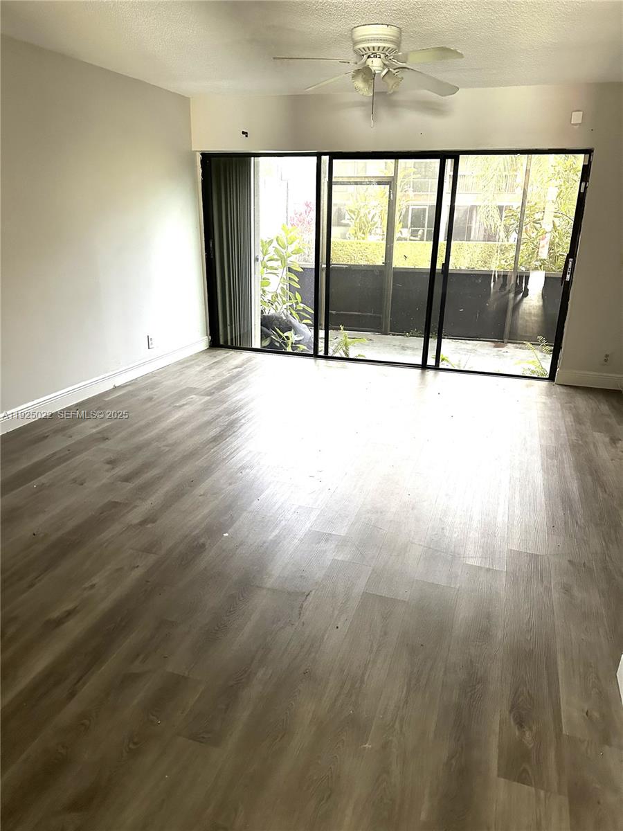 4220 Southwest 71st Terrace Davie, FL 33314 - Photo 16 of 16 a view of an empty room with wooden floor and a window