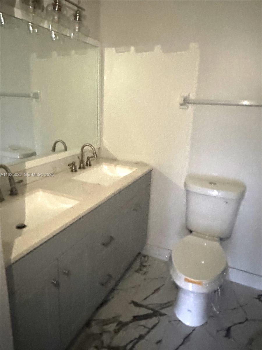 4220 Southwest 71st Terrace Davie, FL 33314 - Photo 6 of 16 a white toilet sitting next to a bathroom sink