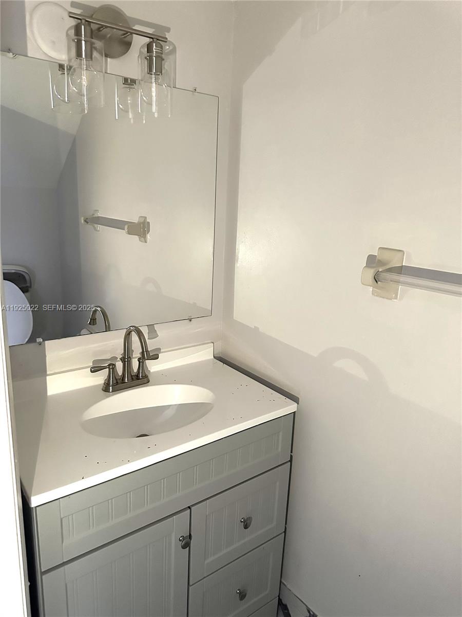 4220 Southwest 71st Terrace Davie, FL 33314 - Photo 9 of 16 a bathroom with a sink and a mirror