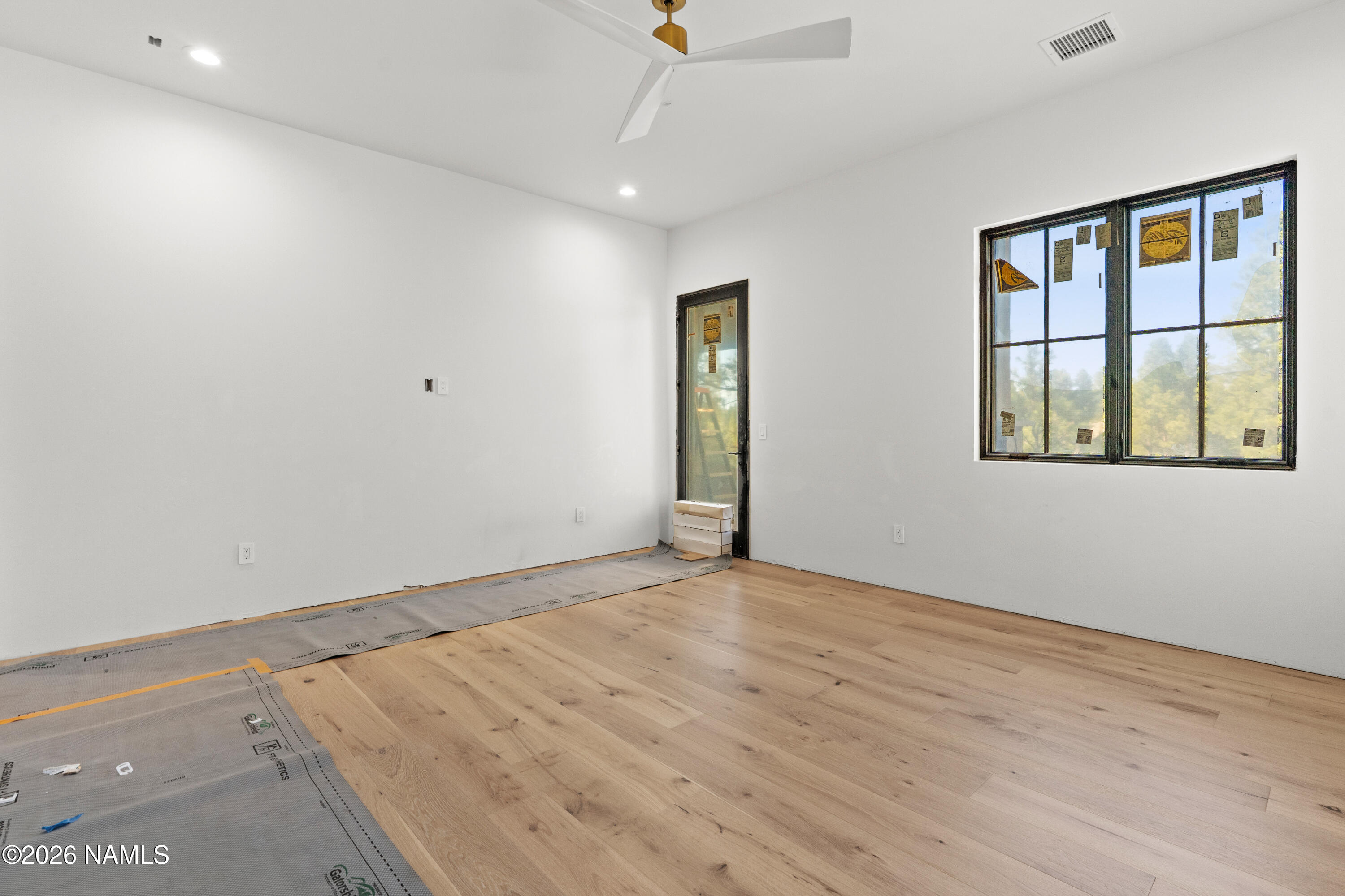 3440 South Pimlico Flagstaff, AZ 86005 - Photo 12 of 18 an empty room with wooden floor and windows
