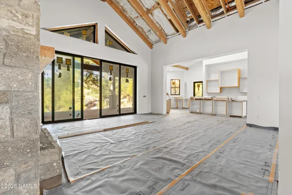 a spacious bedroom with a large bed and a large window