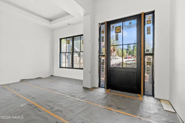 a view of a hallway with wooden floor and a fireplace