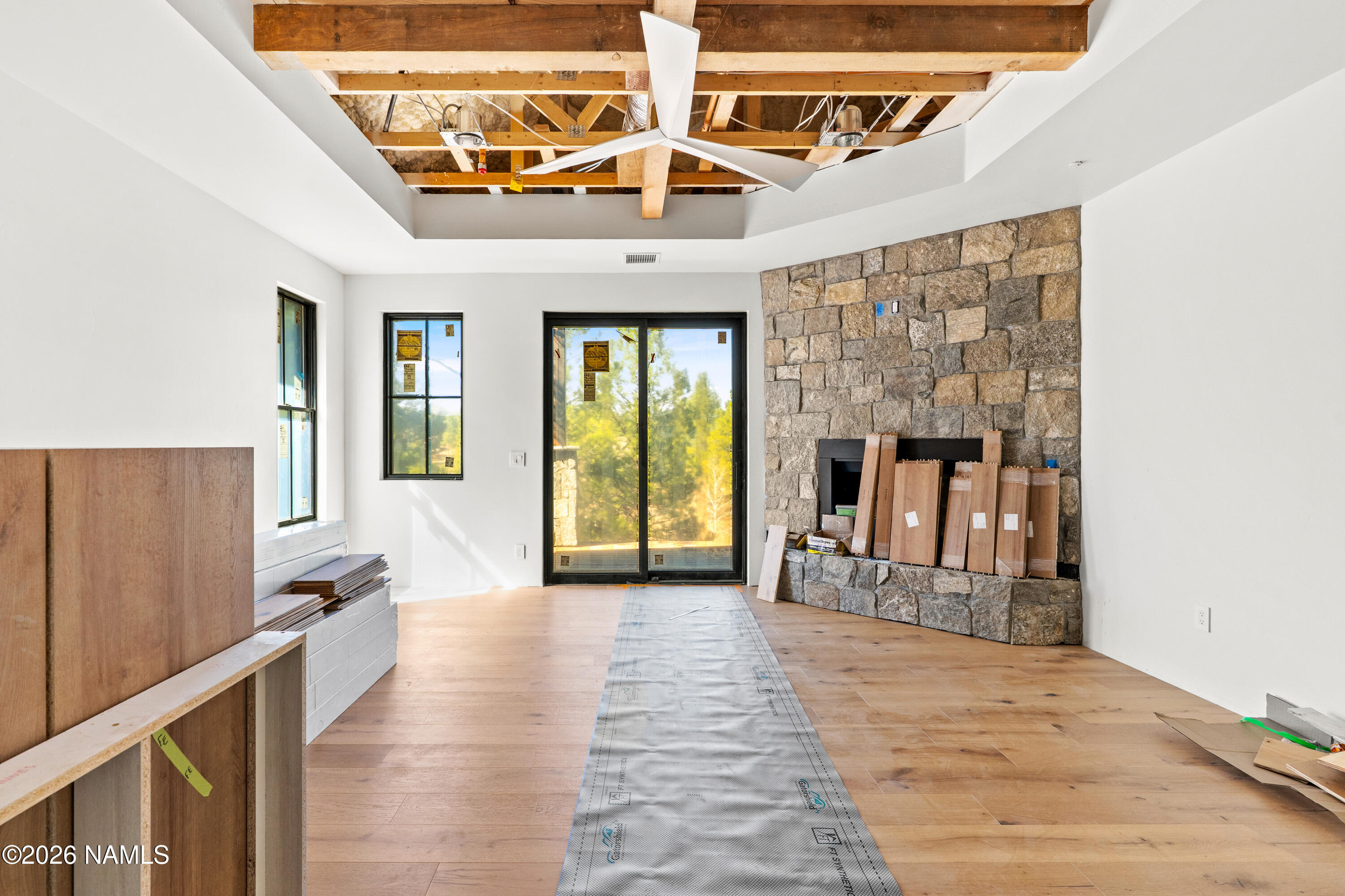 3440 South Pimlico Flagstaff, AZ 86005 - Photo 9 of 18 a view of a hallway with wooden floor and a fireplace