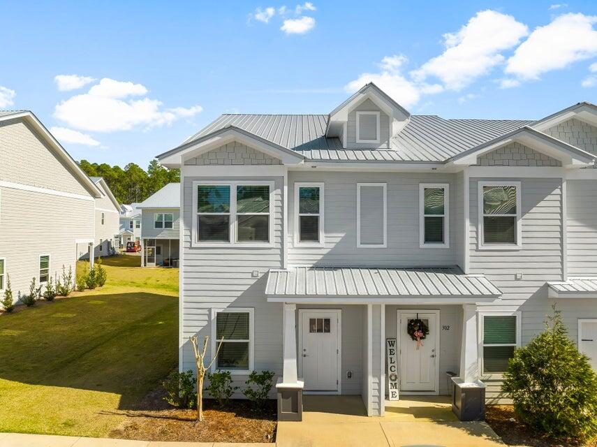 314 Date Palm Lane, Unit HORIZON Freeport, FL 32439 - Photo 1 of 25 a front view of a house with a yard