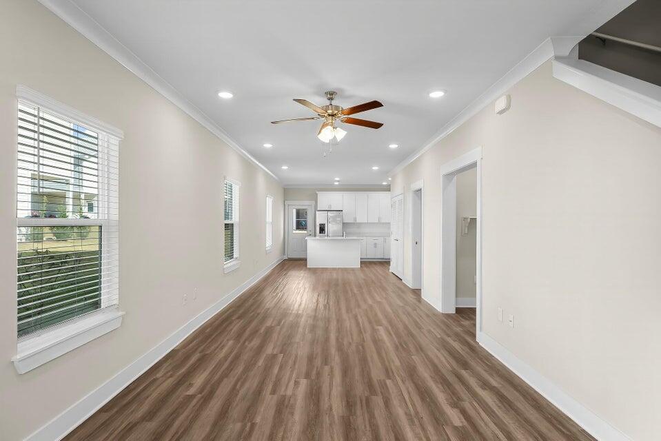 314 Date Palm Lane, Unit HORIZON Freeport, FL 32439 - Photo 7 of 25 a view of a big room with wooden floor a chandelier fan and windows